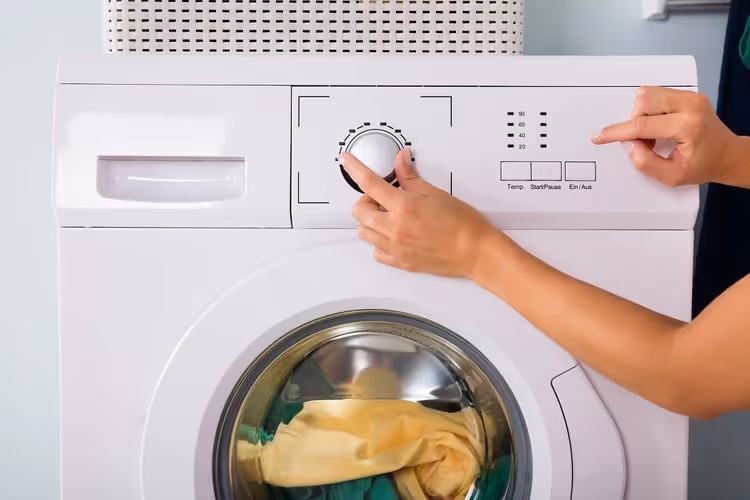 Built-in washing machine under countertop in bathroom