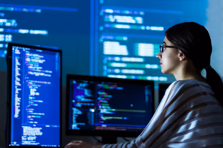 Programmer working with Python code on a laptop