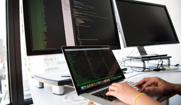 shallow focus photo of person using MacBook