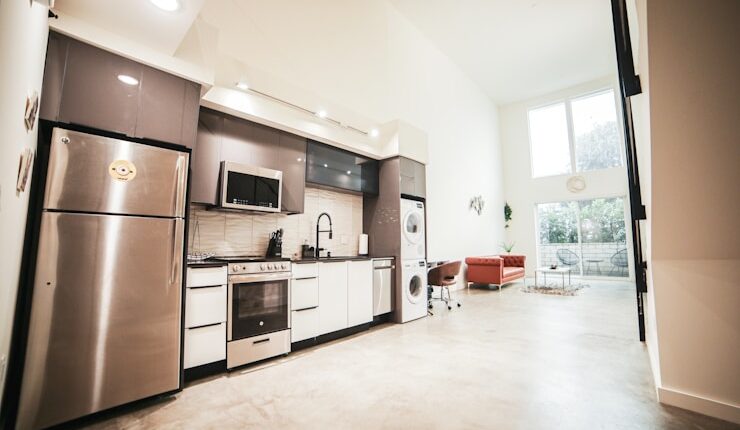 brown wooden kitchen cabinet near white wall