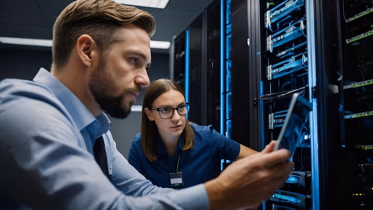 System administrator monitoring a server rack